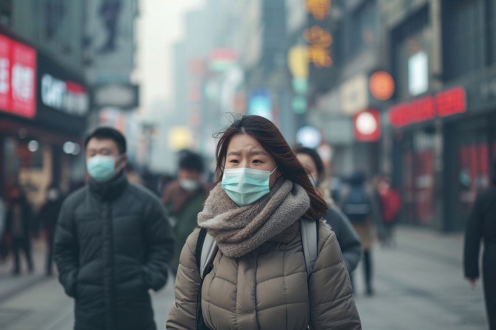 People wearing face mask outdoors walking street.