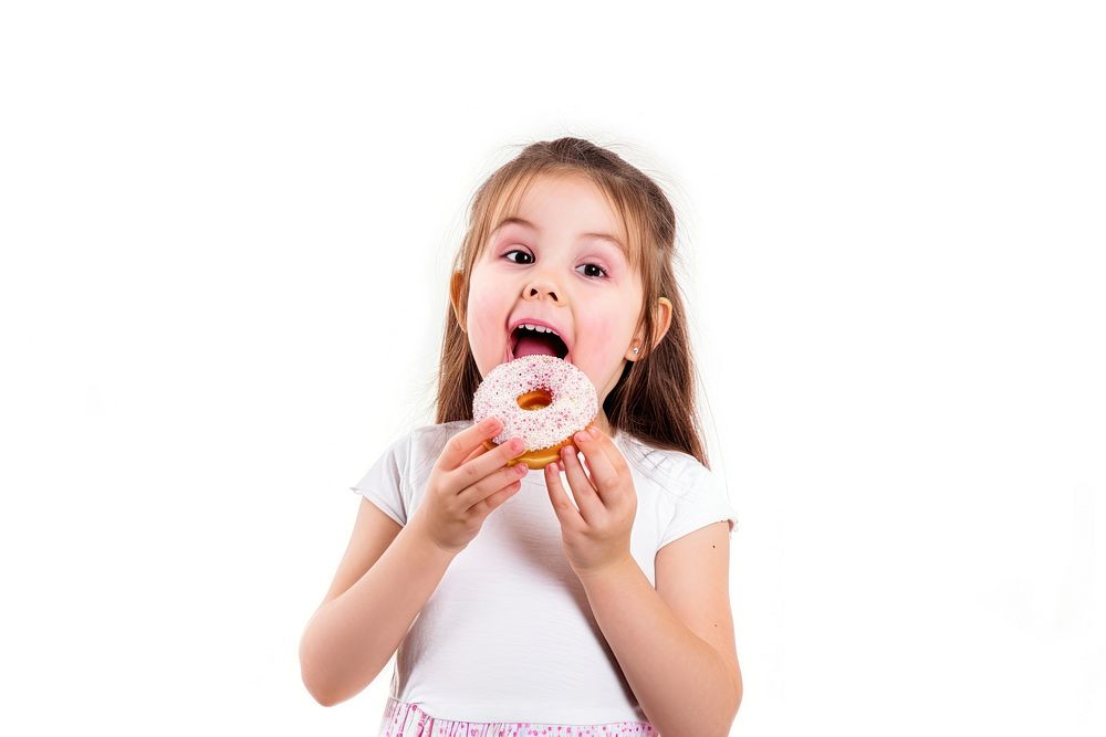 Little girl holding donut eating child food.