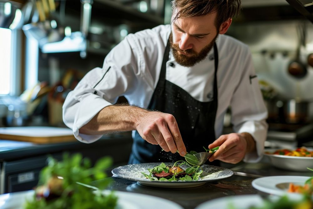 Chef garnishing food kitchen adult male. 