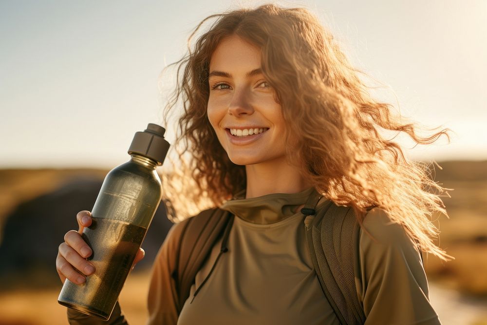 Woman holding water bottle portrait smile photo. 