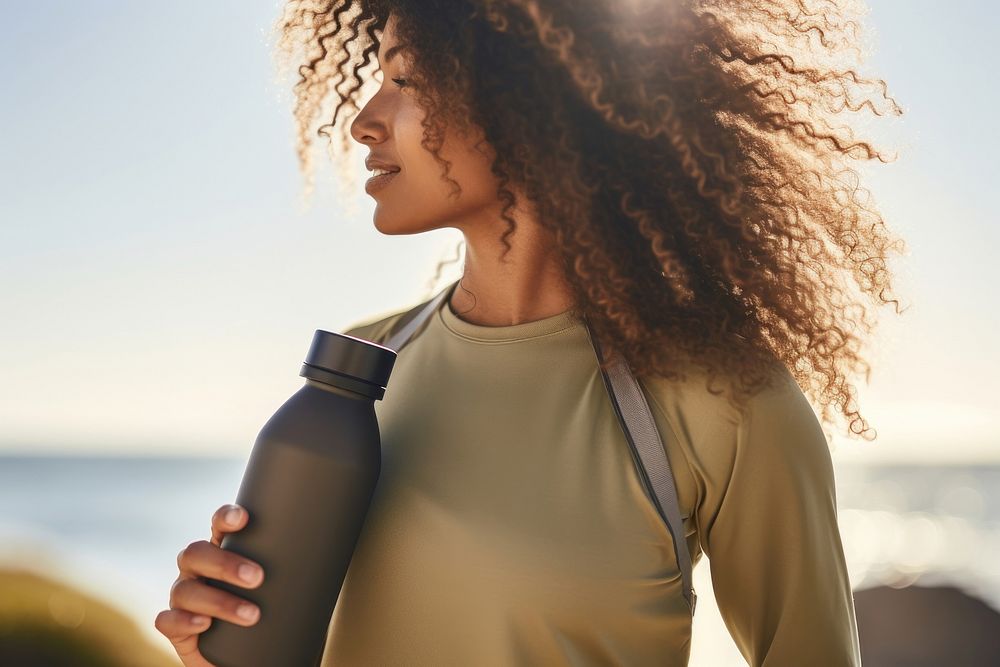 Woman holding water bottle sports adult exercising. AI generated Image by rawpixel.