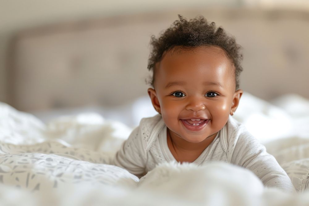 African american baby girl smiling smile bed.