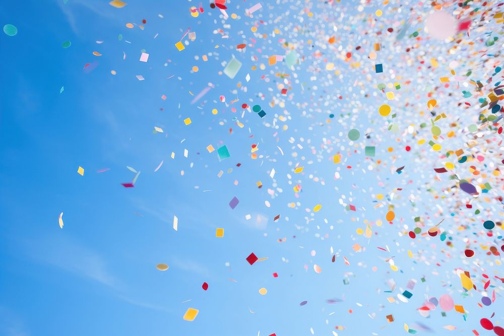 Colorful confetti against clear blue sky low angle view backgrounds celebration. AI generated Image by rawpixel.