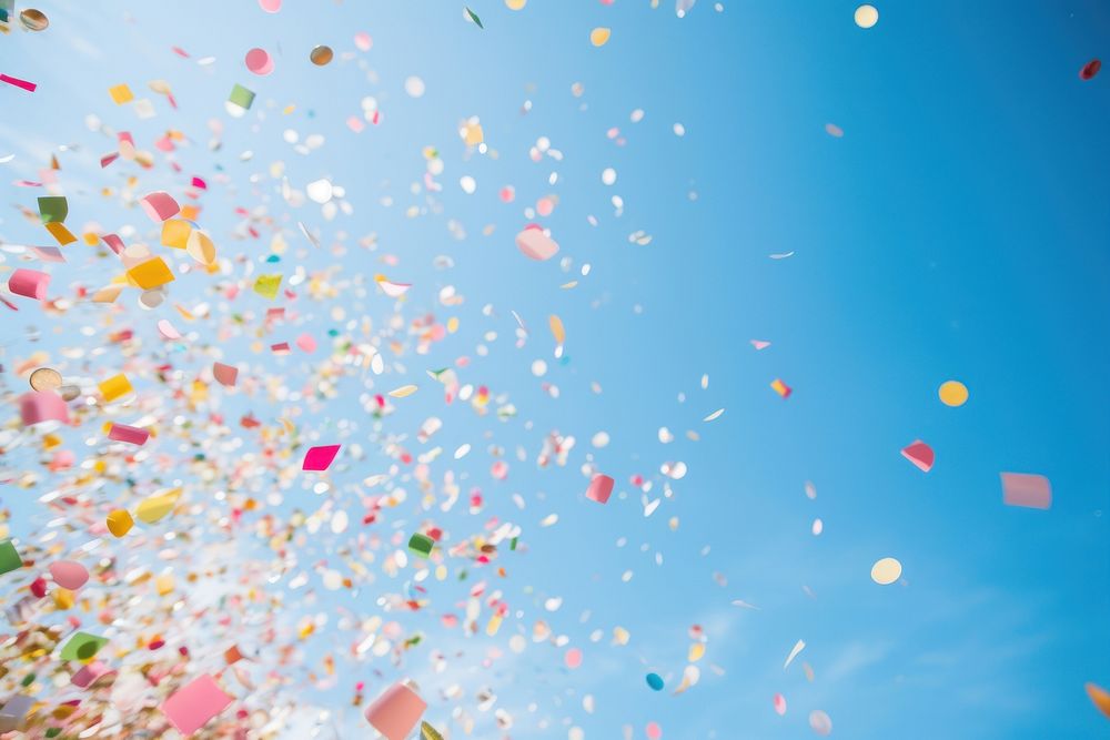 Colorful confetti against clear blue sky outdoors low angle view backgrounds. AI generated Image by rawpixel.