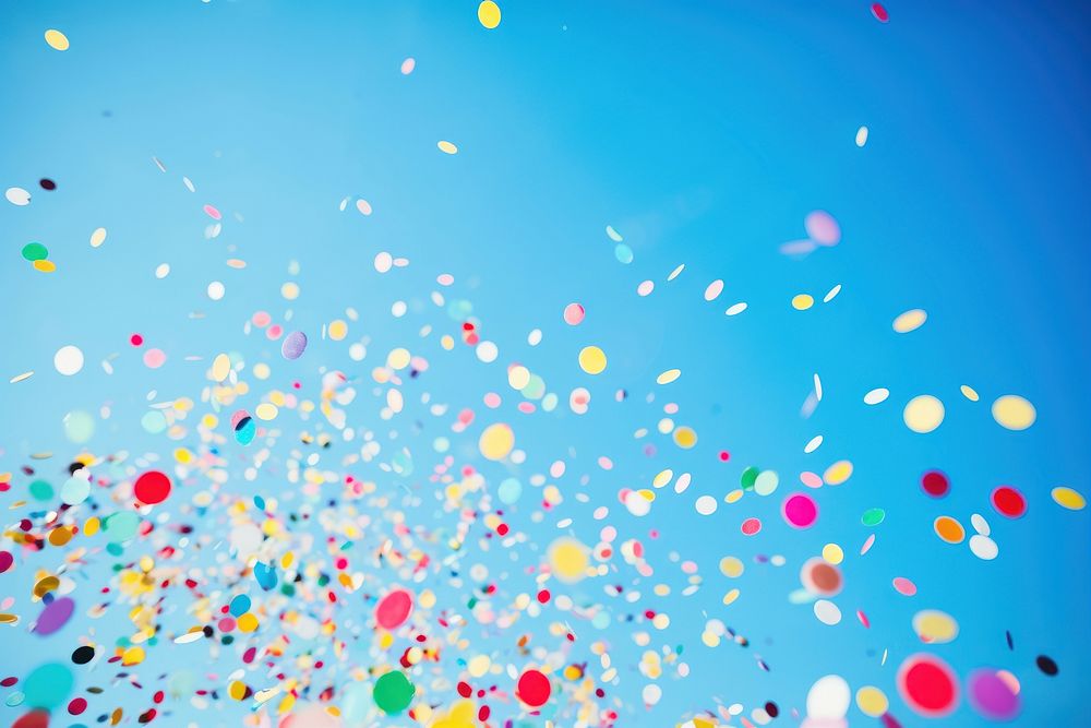 Colorful confetti on clear blue sky background backgrounds celebration decoration. AI generated Image by rawpixel.