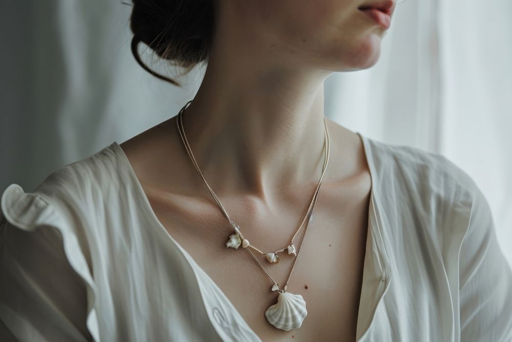 Woman wearing shell jewellery necklace jewelry pendant.