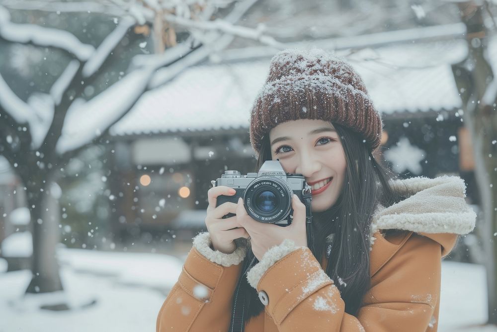 Japanese woman camera snow outdoors.