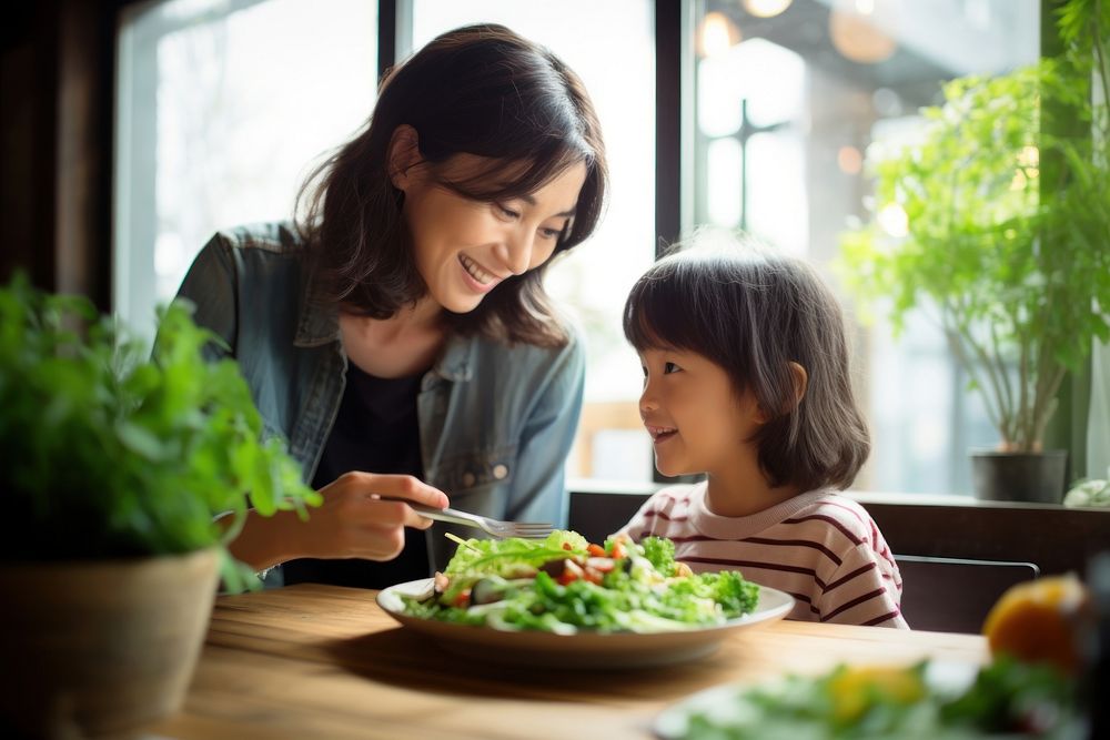 Japanese mother and kid eating healthy salad restaurant child adult. AI generated Image by rawpixel.