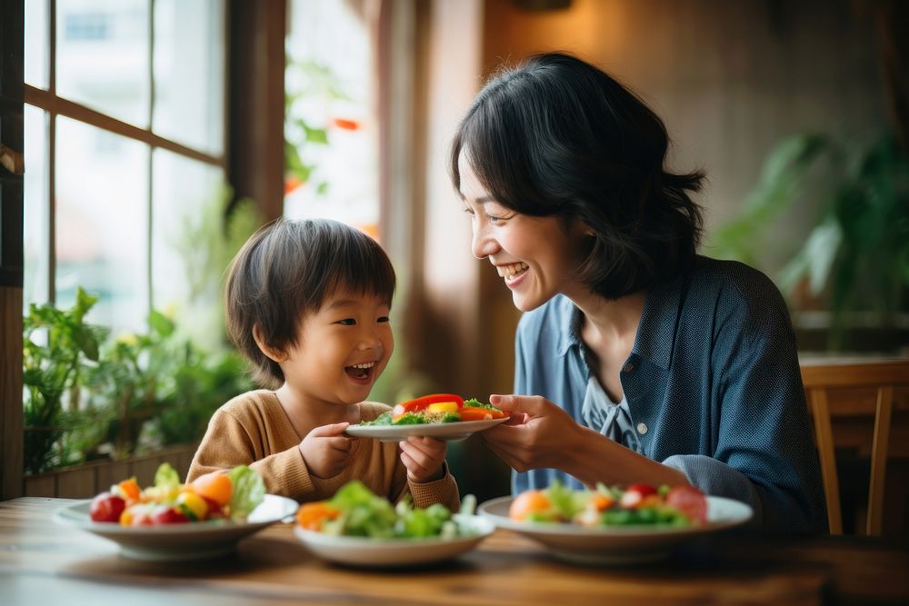 Japanese mother and kid eating healthy salad restaurant adult baby. AI generated Image by rawpixel.