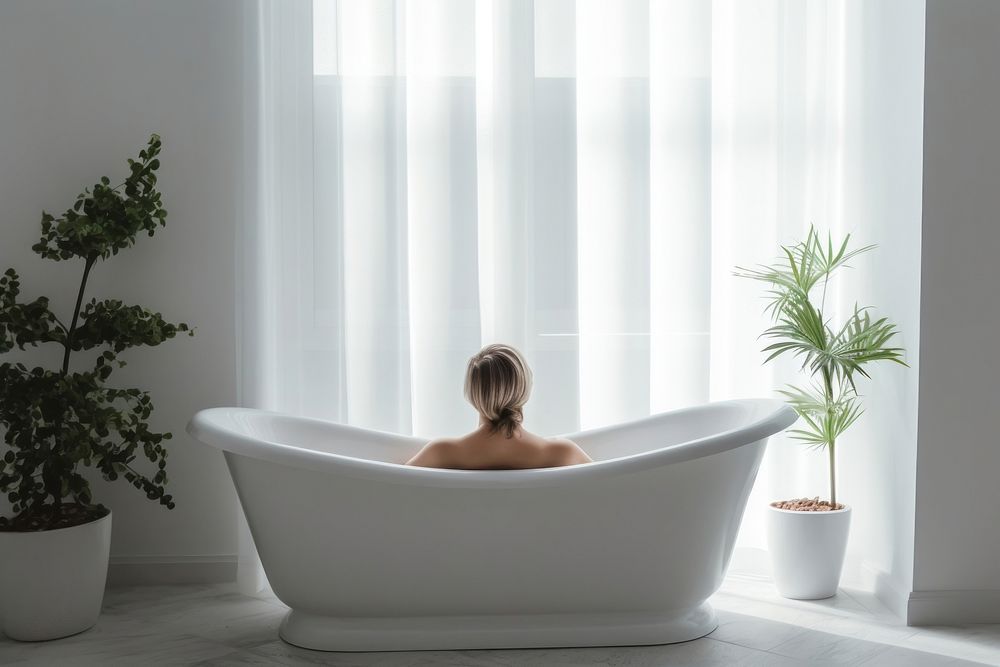 Person bathtub jacuzzi plant.