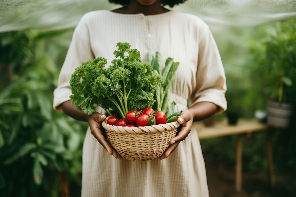 Black woman vegetable gardening outdoors.