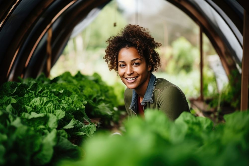 Black woman greenhouse vegetable outdoors.