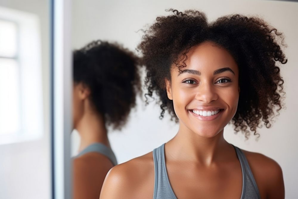 Black woman smiling mirror sports.