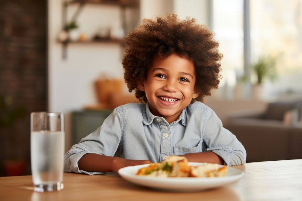African-American little boy portrait smiling dinner.