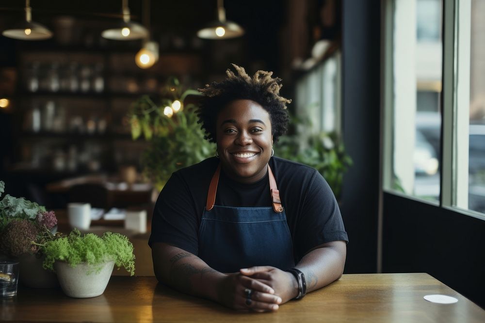 Chubby black male chef restaurant smiling table.