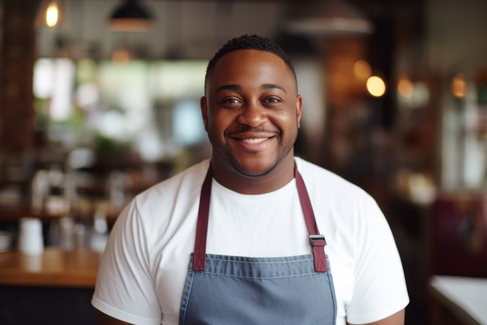 African American male chef restaurant smiling waiter.