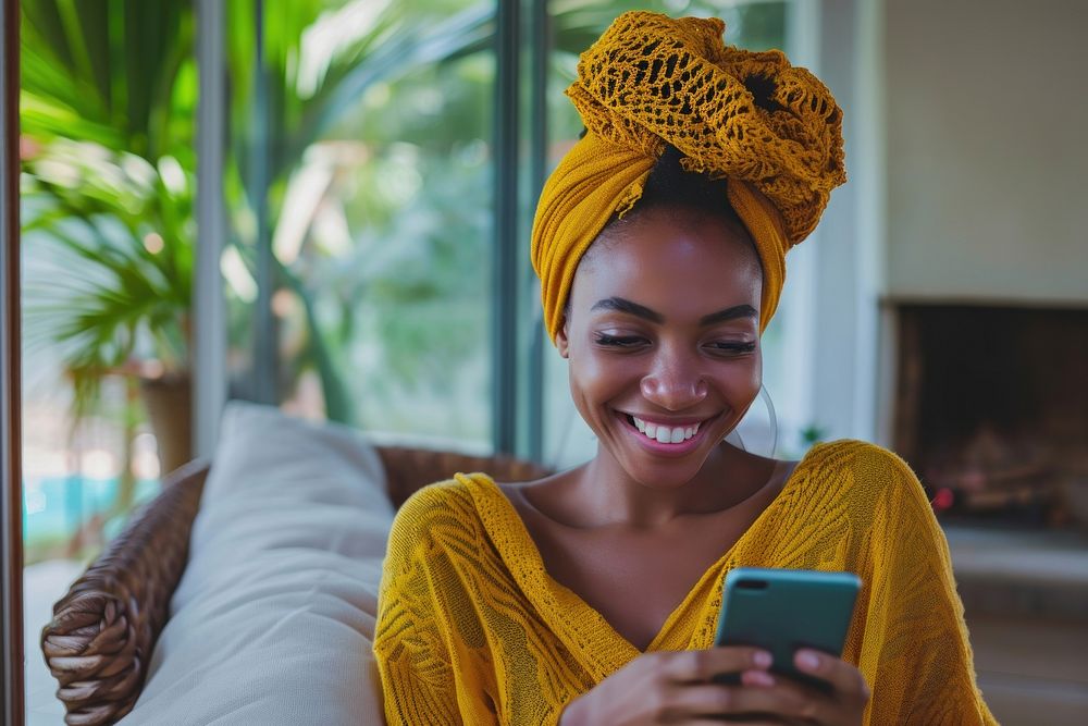 African turban using smartphone portrait smiling portability.