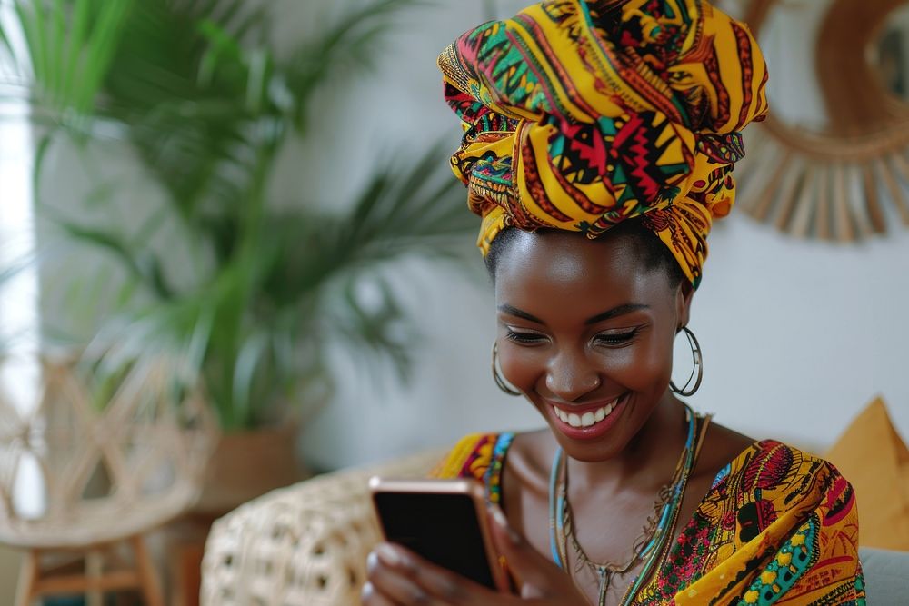 African turban using smartphone portrait smiling adult.