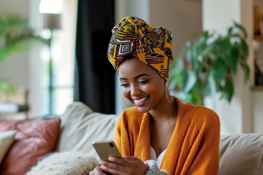 African turban using smartphone portrait smiling photography.