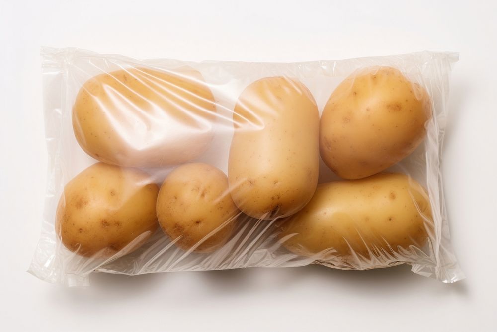 Plastic wrapping over a potato vegetable plant food.