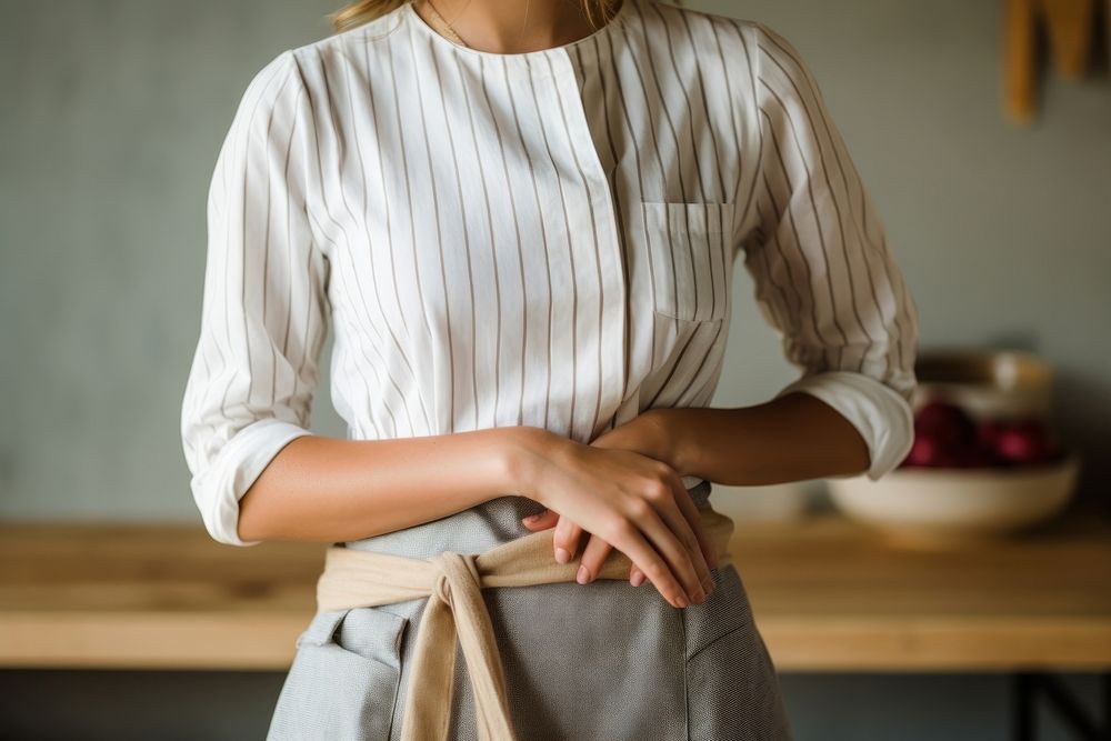 Woman wearing a white apron with a tiered waist blouse sleeve adult. AI generated Image by rawpixel.