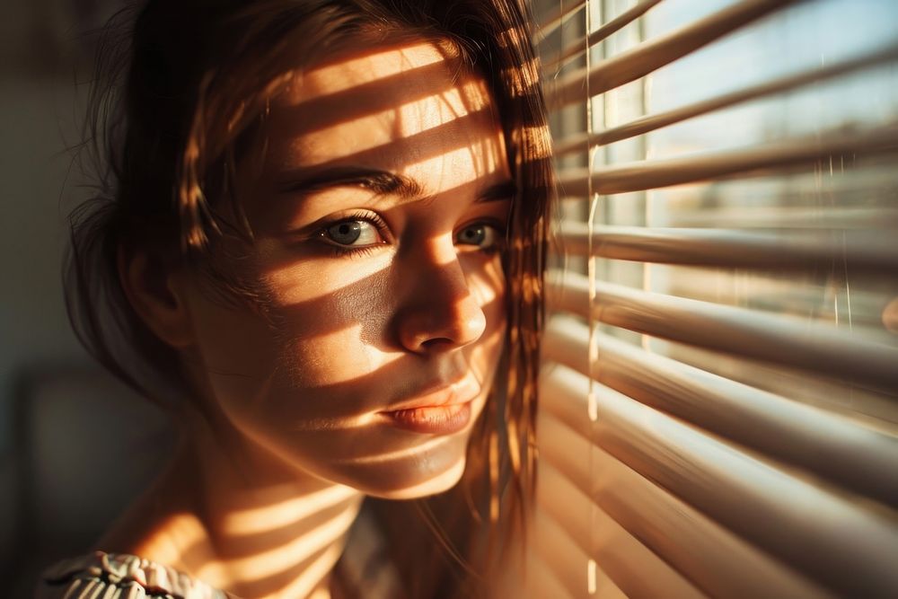 Woman looking through window portrait sunlight blinds. AI generated Image by rawpixel.
