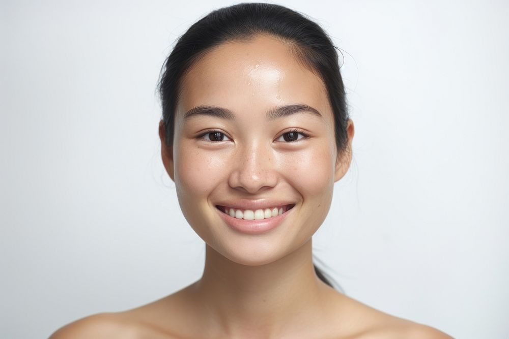 Close up Southeast Asian woman no make up smile skin white background.