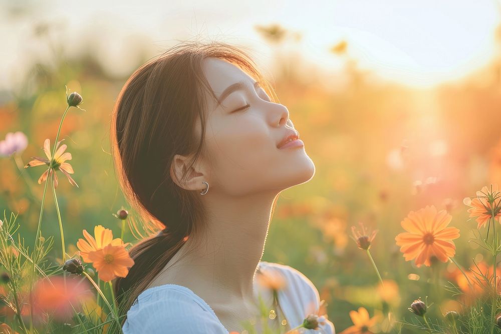 Photo of asian woman in flower field outdoors nature summer.