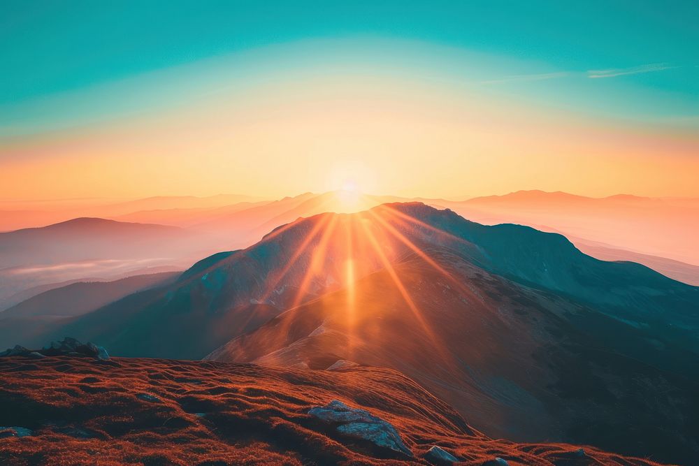 Photo of behind a mountain sunlight sunset sky.