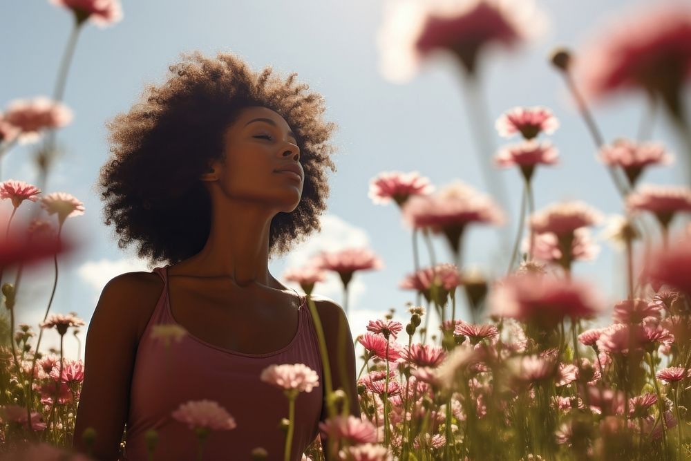 Photo of black woman in flower field outdoors summer plant.