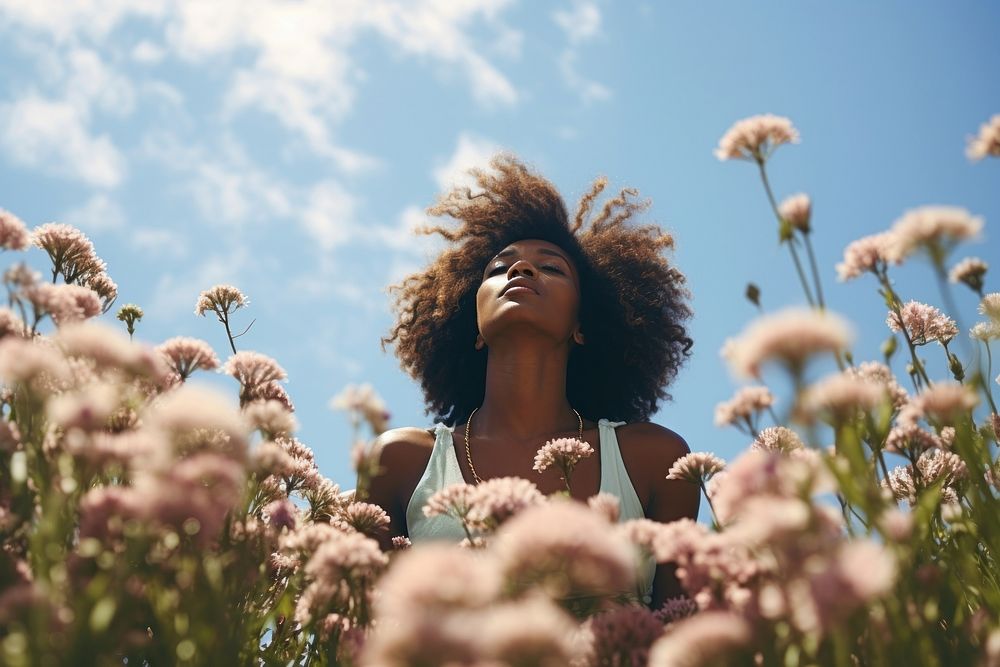 Photo of black woman in flower field summer adult tranquility.