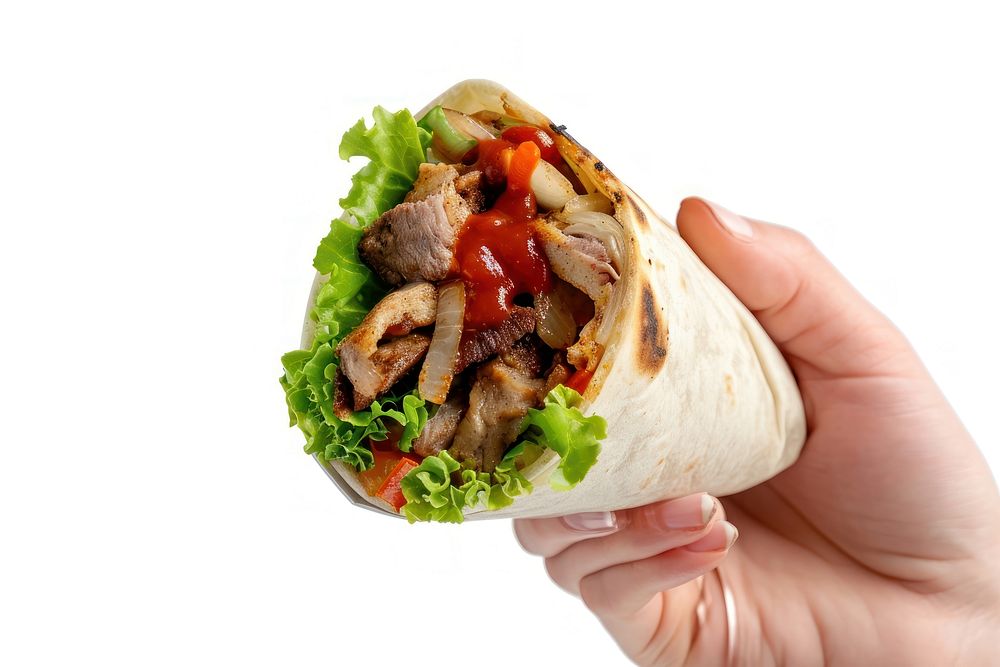 Female hand holds shawarma with red sauce bread food meat.