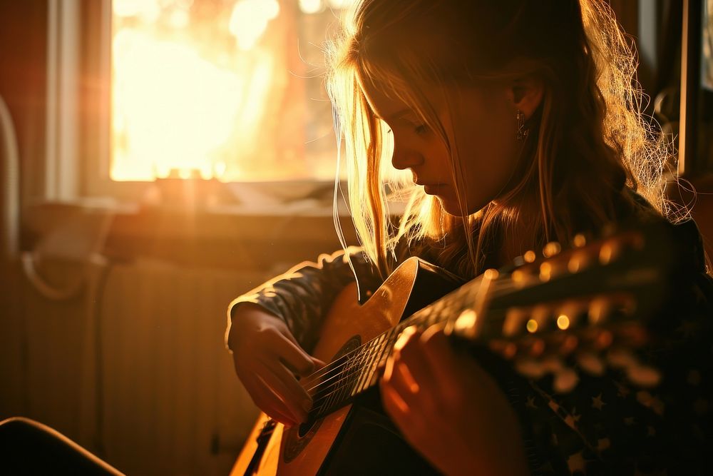 Girl playing the guitar musician light adult