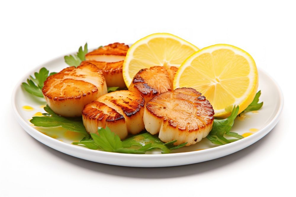 Grilled scallops with lemon slices and greens fruit plate food.