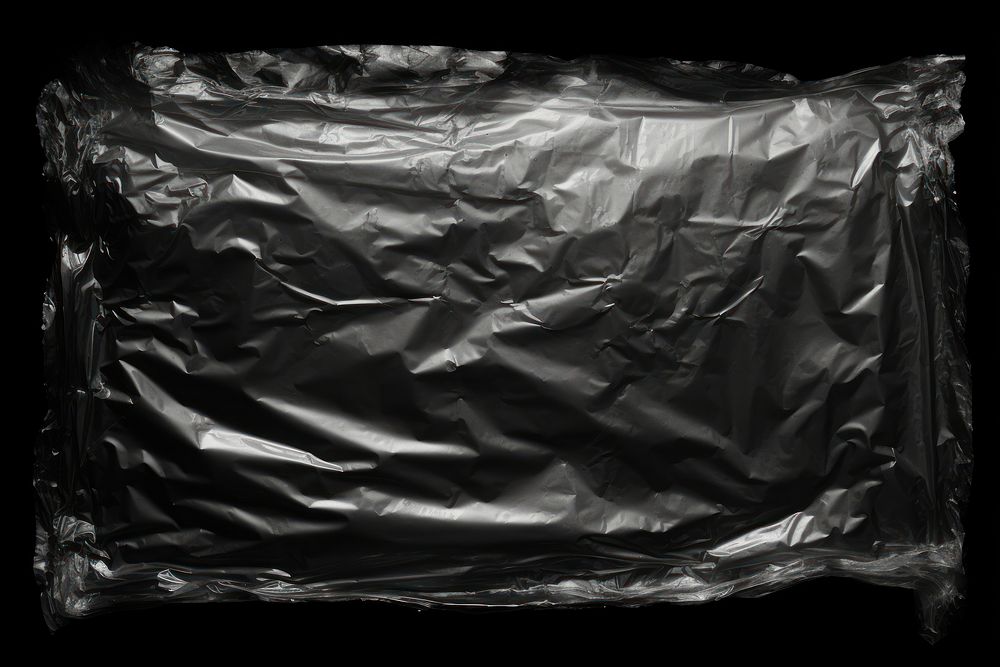 Ripped plastic wrap in the middle backgrounds black black background.