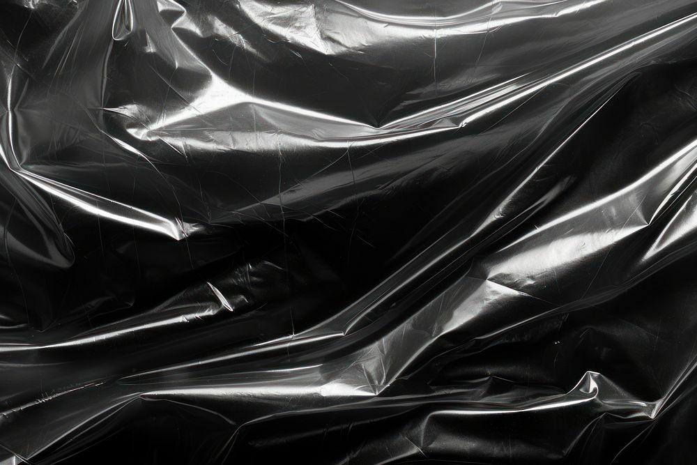 Sheeting of various sizes plastic wrap black backgrounds abstract.