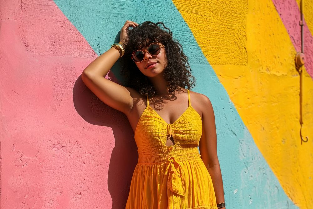 Latina woman in a sundress standing in front of a colorful wall fashion summer adult. AI generated Image by rawpixel.