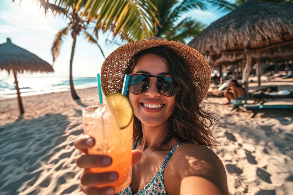 Selfie Latina woman holding a tropical drink on a beach vacation summer relaxation. AI generated Image by rawpixel.