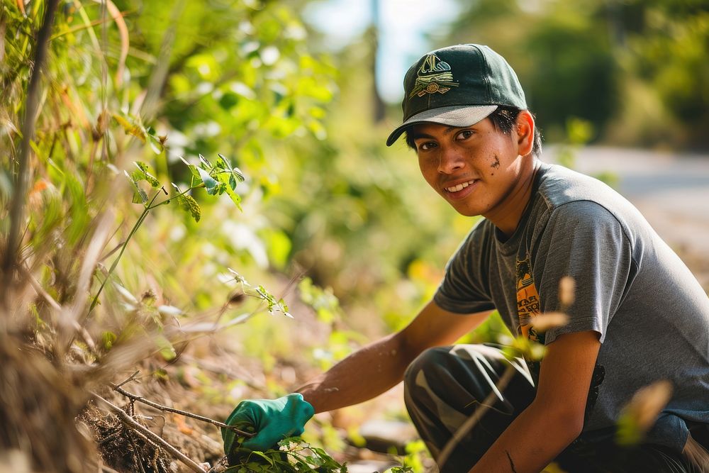 A young Latino environmentalist leading a community cleanup campaign outdoors gardening nature. AI generated Image by…