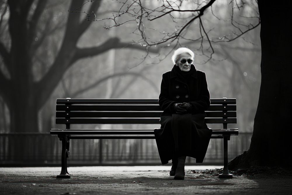 Photography old woman sitting monochrome bench.