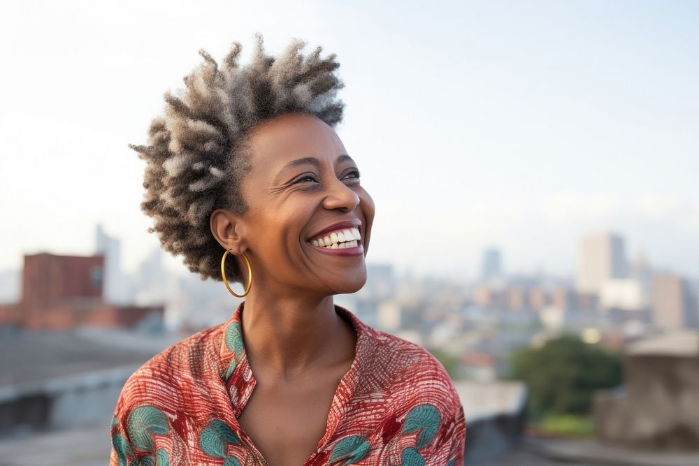 African woman wearing casual attire laughing smiling smile.