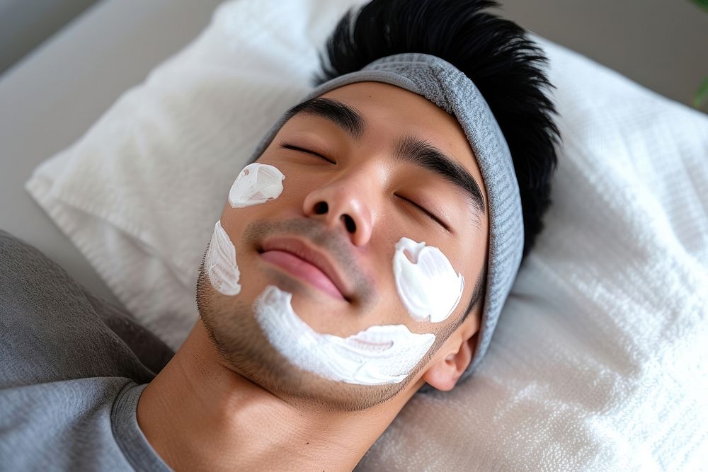 Singaporean men applying cream adult relaxation headshot.