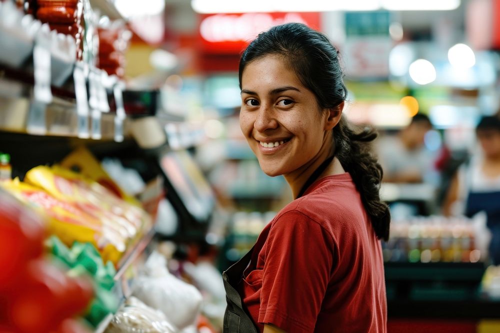 Smiling latino cashier in supermarket smile adult consumerism. AI generated Image by rawpixel.