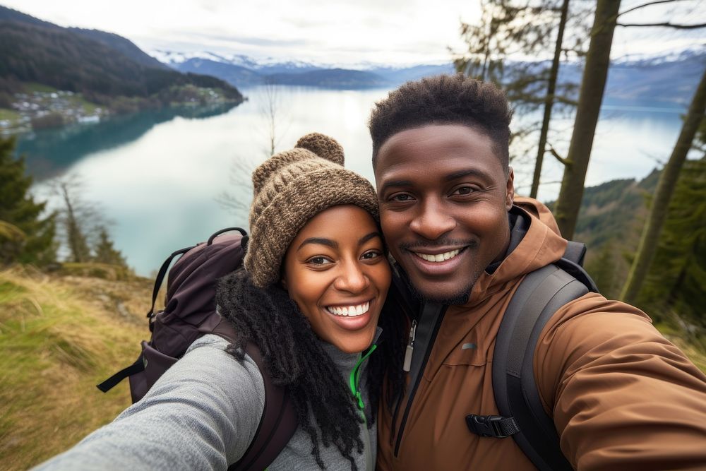 African couple traveler taking a selfie hiking adventure portrait.