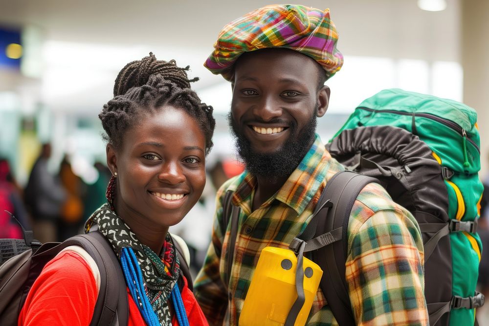 Ghanan couple backpacker at the airport portrait adult smile.