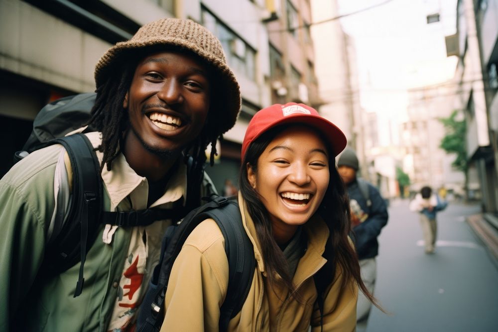 Two African people Backpackers in tokyo laughing portrait outdoors.