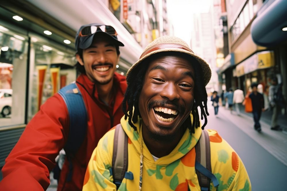 Two African people Backpackers in tokyo laughing portrait outdoors.