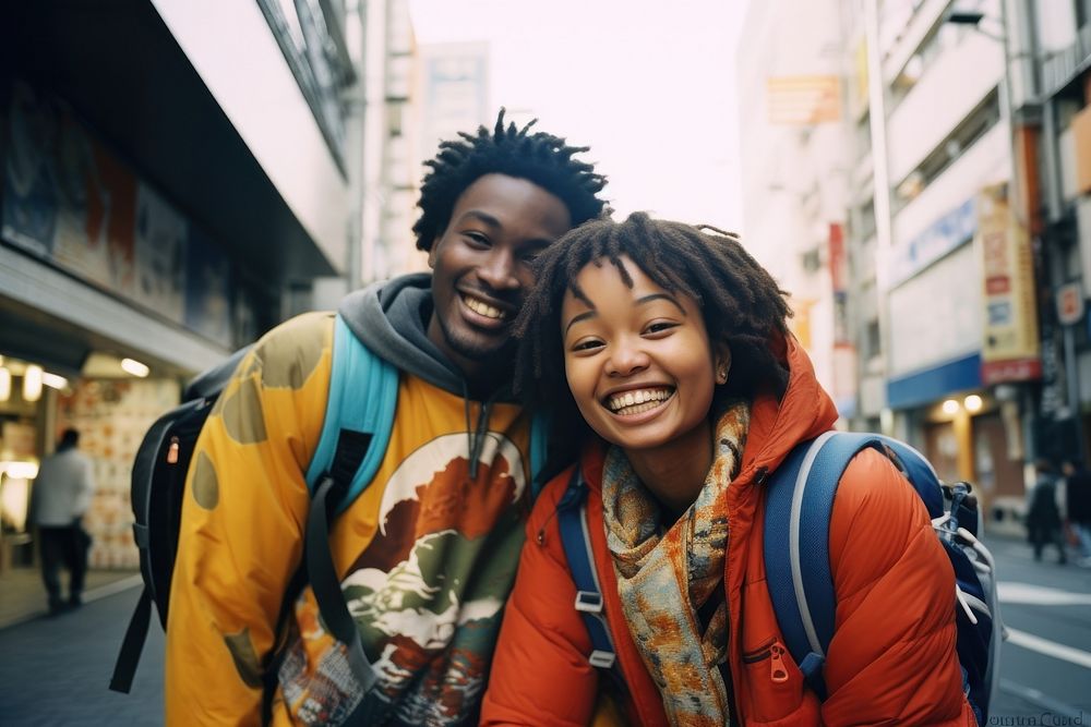 Two African people Backpackers in tokyo laughing outdoors backpack.