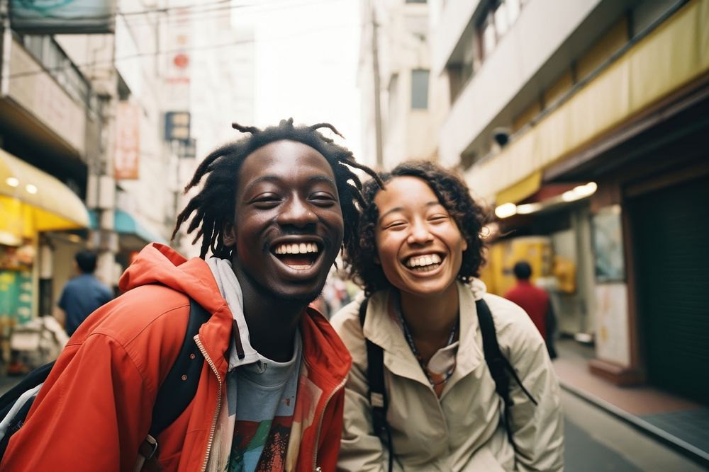 Two African people Backpackers in tokyo laughing outdoors smile.