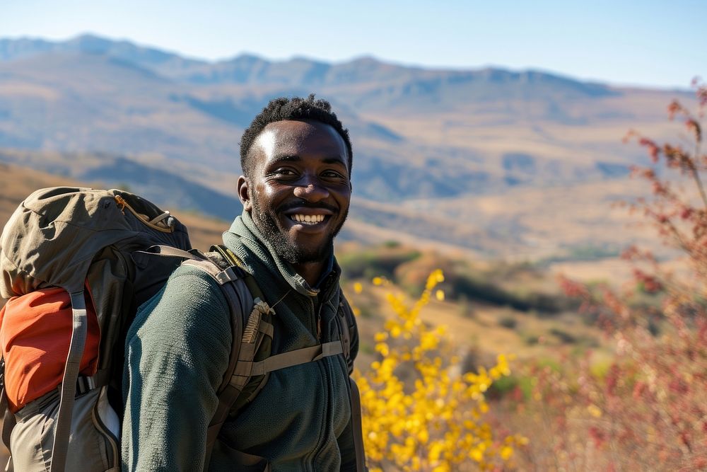 African man hiking backpacking mountain smile.